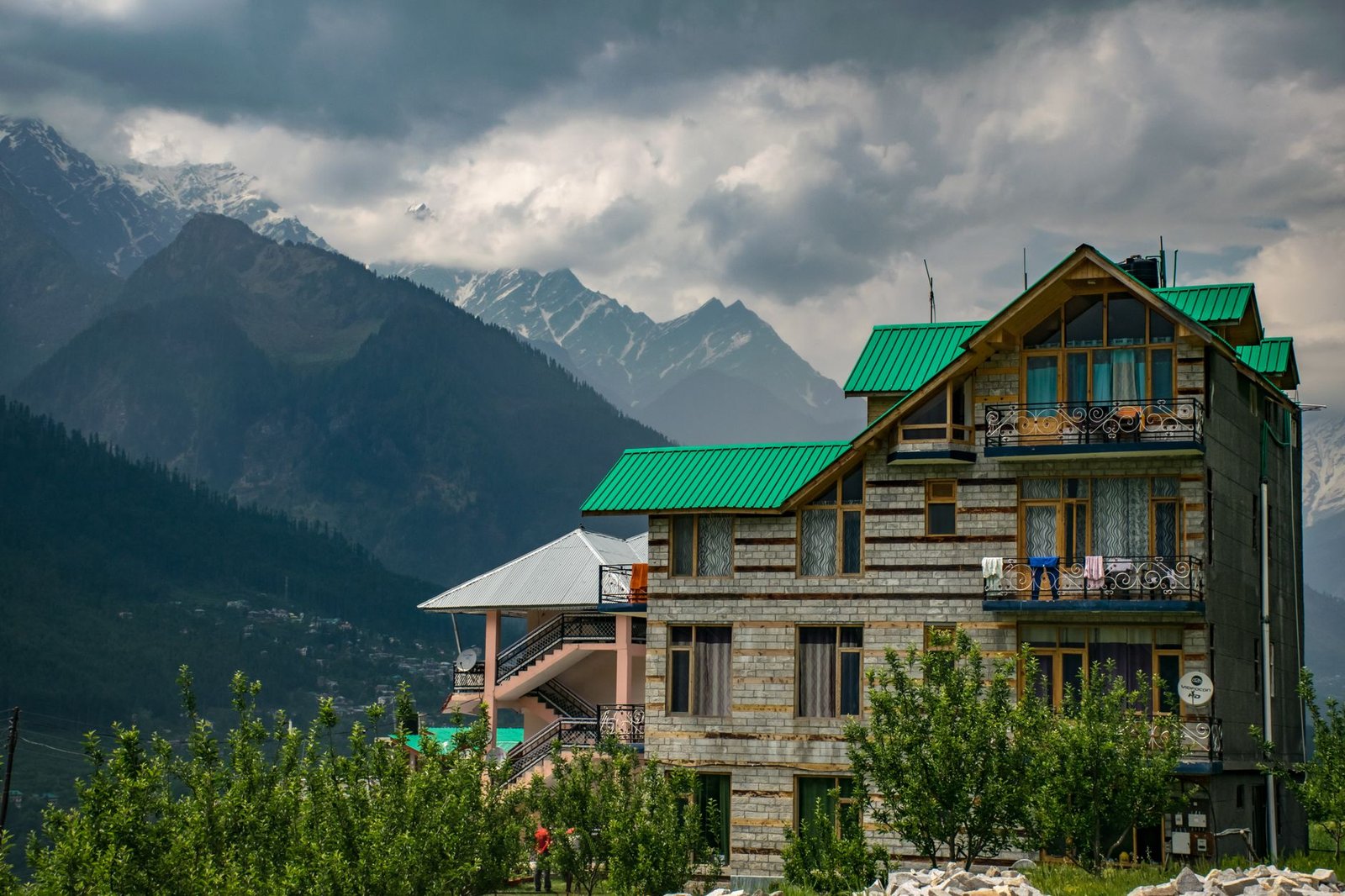 brown and green concrete building near mountains at daytime