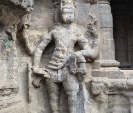 A statue on the walls of the Kailasa Temple